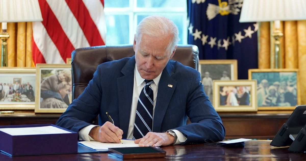 President Joe Biden signs the American Rescue Plan on March 11, 2021, in the Oval Office of the White House in Washington, D.C.