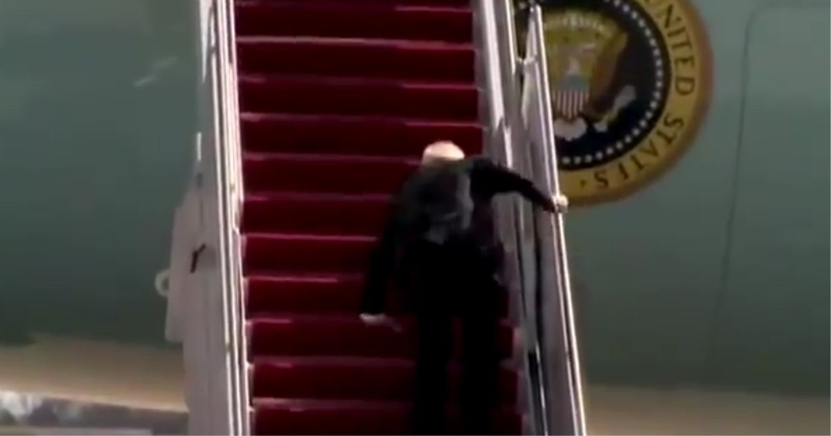 President Joe Biden stumbles multiple times while walking up the steps to Air Force One on Friday.