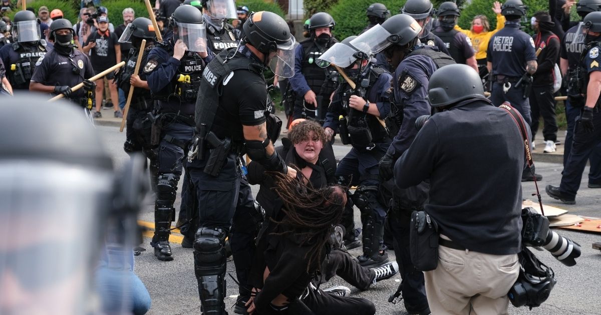 Riot police arrest protesters in Louisville, Kentucky, on Sept. 23, 2020.