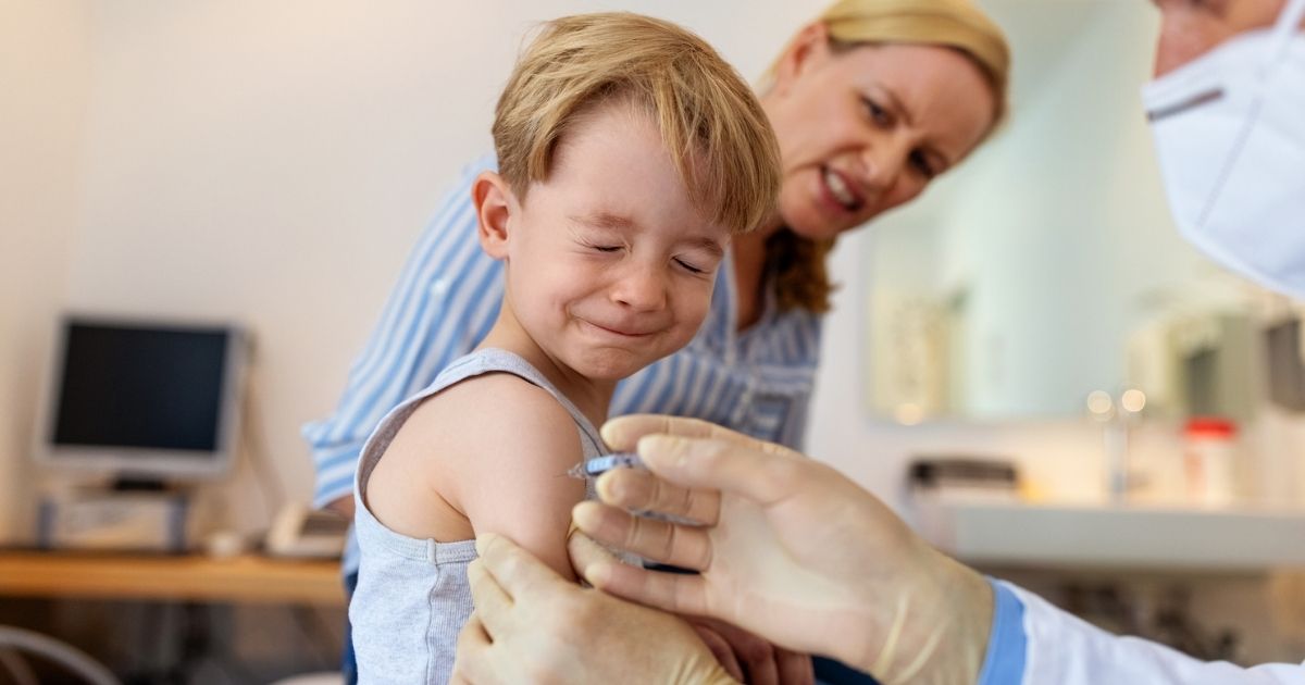 The above stock photo shows a little kid getting a vaccine shot.