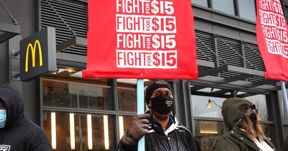 People protest in support of a $15-per-hour minimum wage outside of McDonald's corporate headquarters in Chicago on Jan. 15.