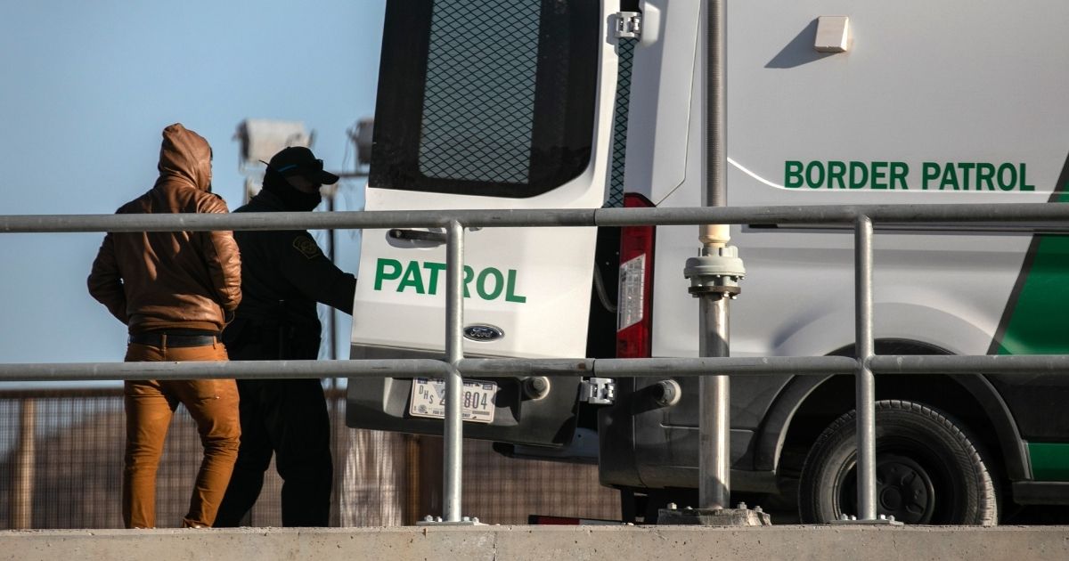 A Border Patrol agent detains an immigrant who had crossed the U.S.-Mexico border near El Paso, Texas, on Tuesday.