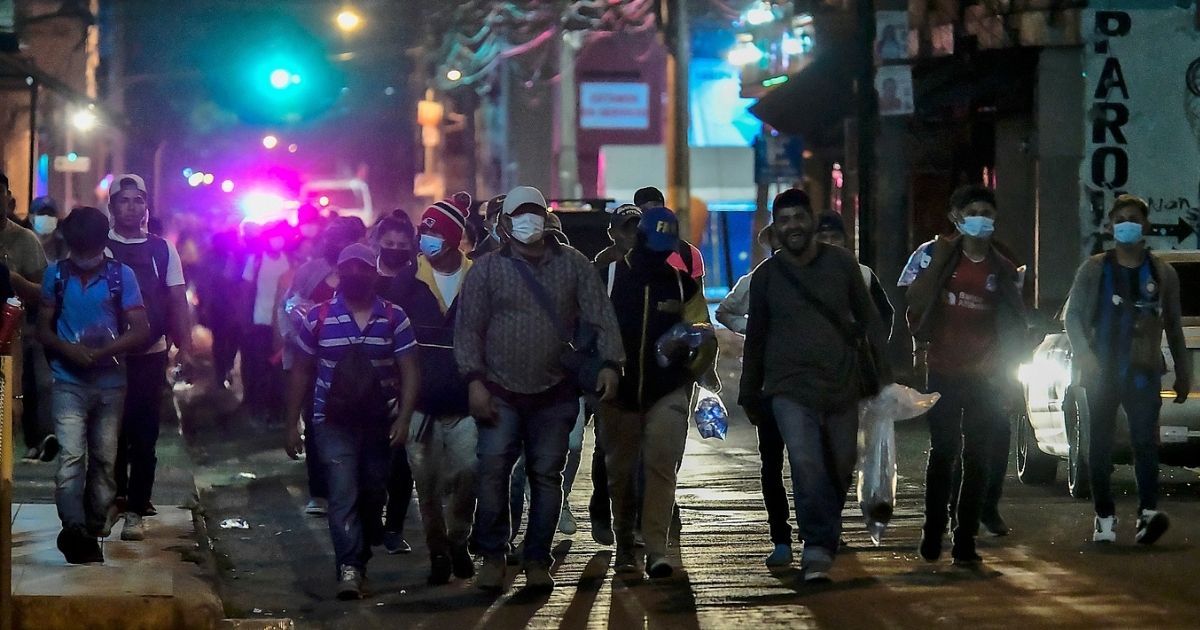 U.S.-bound migrants begin walking in a caravan from San Pedro Sula, Honduras, toward Corinto, on the border with Guatemala, on Wednesday.