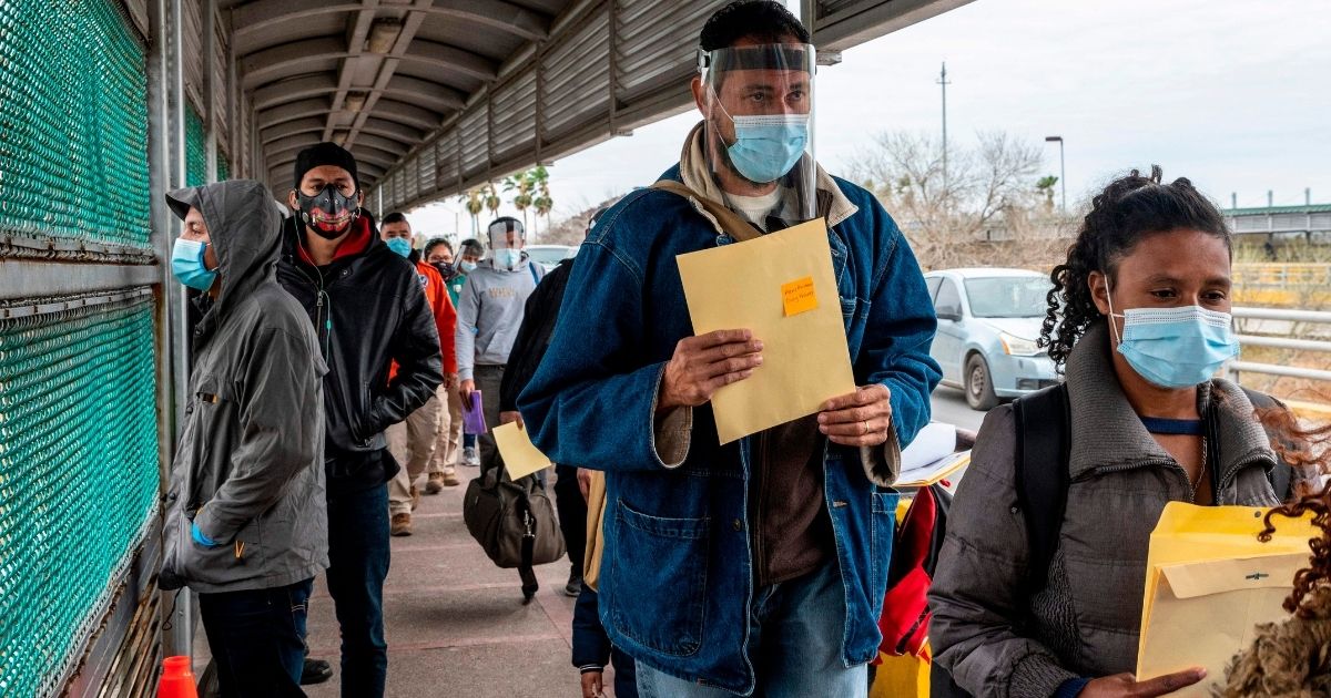 Migrants prepare to cross the U.S. border on the Gateway International Bridge in Brownsville, Texas, on March 2.