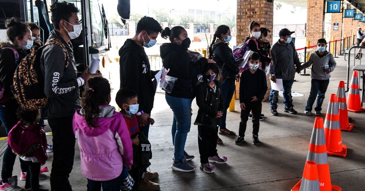 Migrants are dropped off by U.S. Customs and Border Protection officials at a bus station in Brownsville, Texas, on March 15.