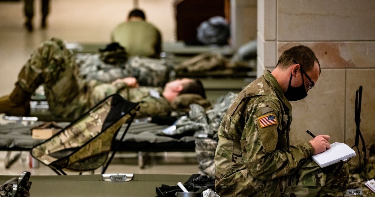 National Guard soldiers rest on cots in the Visitors Center of the U.S. Capitol on Jan. 17, 2021, in Washington, D.C.