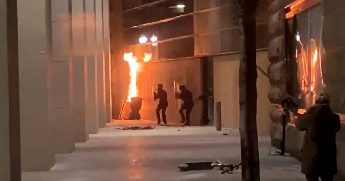 Officers respond after leftist rioters set fire to the federal courthouse in Portland, Oregon.