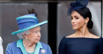 Queen Elizabeth II, left, and Meghan Markle watch a flypast to mark the centenary of the Royal Air Force from the balcony of Buckingham Palace on July 10, 2018, in London, England.