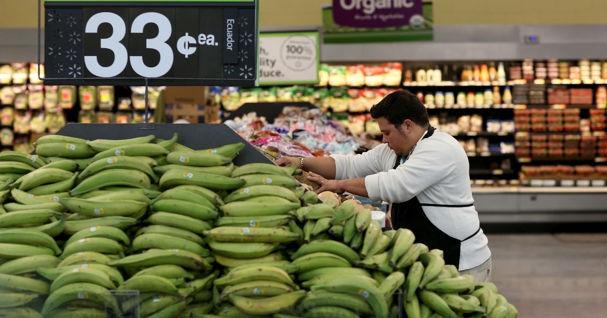 Walmart employee Dayngel Fernandez works in the produce department stocking shelves at a Walmart store on Feb. 19, 2015, in Miami.