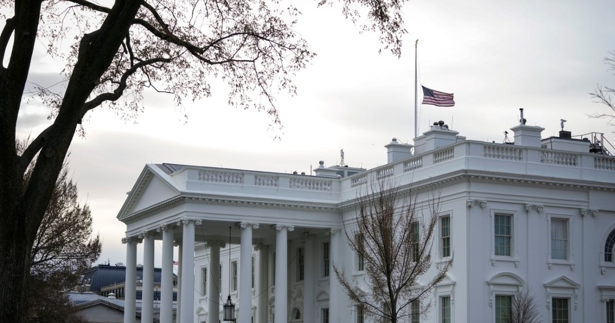 The American flag flies at half-staff at the White House on Friday in Washington, D.C.