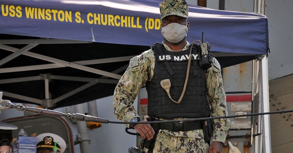 A U.S. sailor looks while standing aboard the U.S. Navy guided-missile destroyer USS Winston S. Churchill, part of Destroyer Squadron 2, while it anchors in Port Sudan on March 1, 2021.