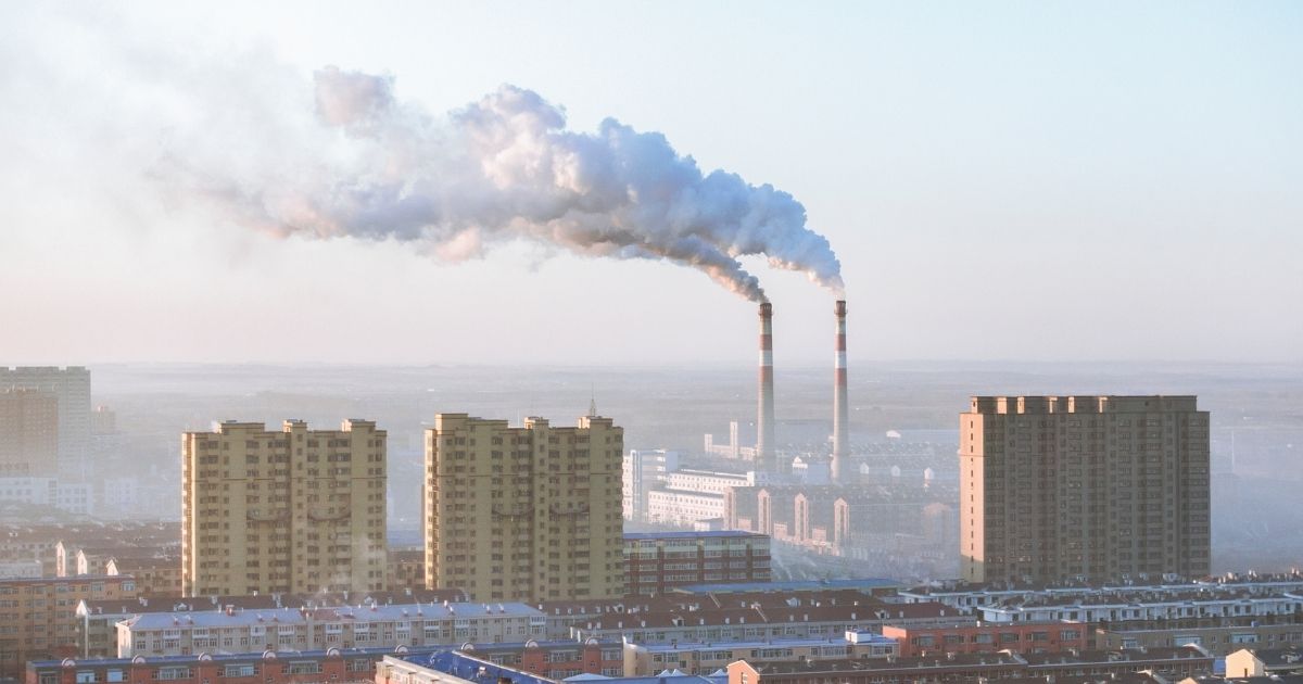Smoke billows out of chimneys at a factory in Beijing.