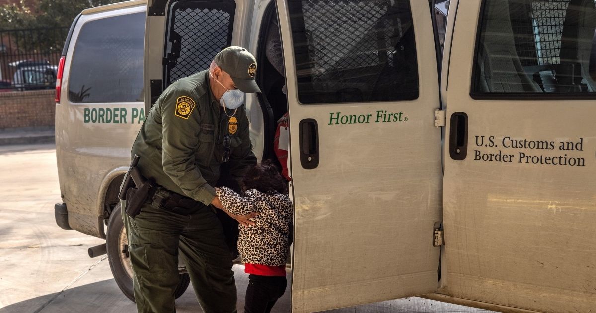 A Border Patrol agent releases a young girl with her family at a bus station in Brownsville, Texas, on Feb. 25.