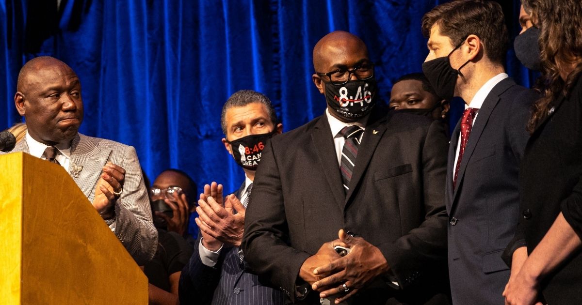 Civil rights attorney Benjamin Crump, left, attorney Antonio Romanucci, and George Floyd's brother, Philonese Floyd, applaud Minneapolis Mayor Jacob Frey at a March 12 news conference announcing the city of Minneapolis would pay the Floyd family $27 million as compensation for Floyd's May 25, 2020, death in the custody of Minneapolis police.