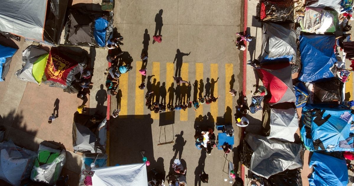 Migrant children are seen in an aerial view attending a class at a migrants camp where asylum seekers wait for US authorities to allow them to start their immigration process outside El Chaparral crossing port in Tijuana, Baja California state, Mexico, on March 17.