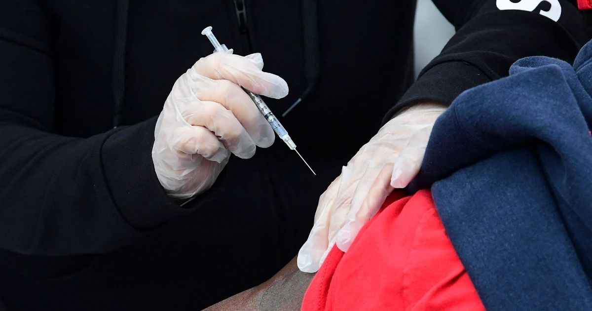 A person receives the Pfizer COVID-19 vaccine at a public housing project pop-up site targeting vulnerable communities in Los Angeles on Wednesday.