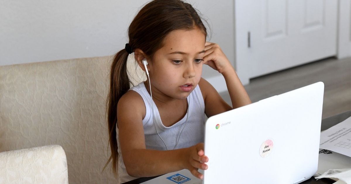 Third-grader Ava Dweck, 9, takes an online class at a friend's home during the first week of distance learning for the Clark County School District in Las Vegas on Aug. 25.