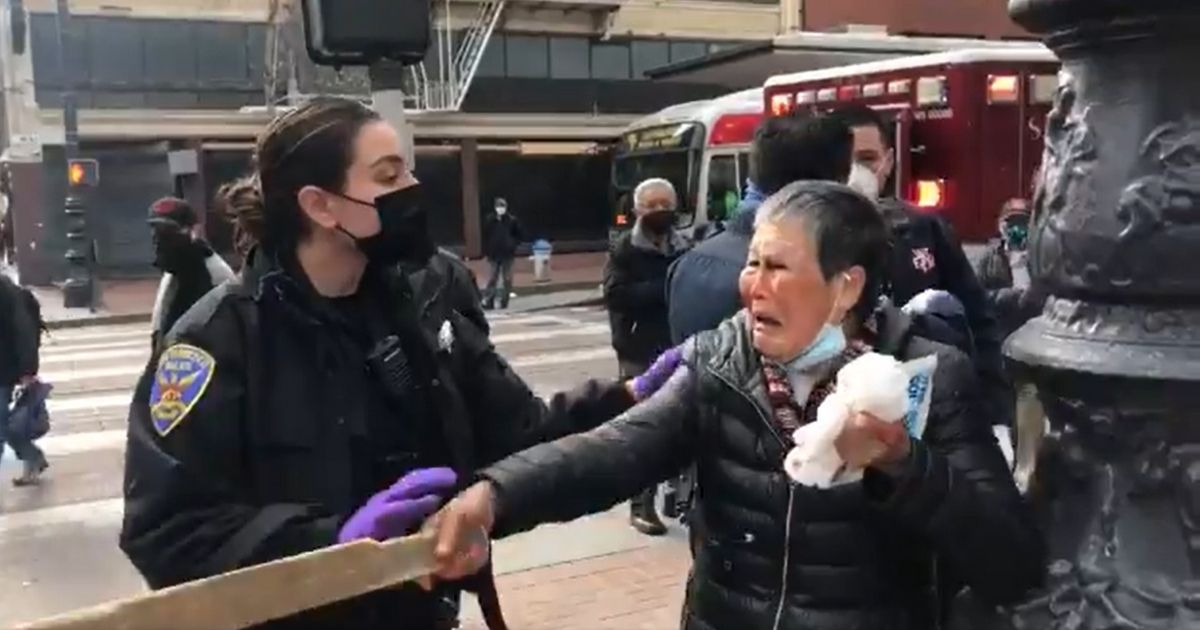 Xiao Zhen Xie points a stick after she was attacked on Market Street in San Francisco on Wednesday morning.