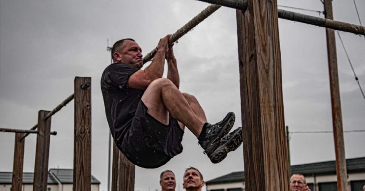 An American soldier performs a leg tuck exercise, one of the elements of Army Combat Fitness Test critics say discriminates against female soldiers.