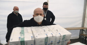 Men unloading COVID vaccine
