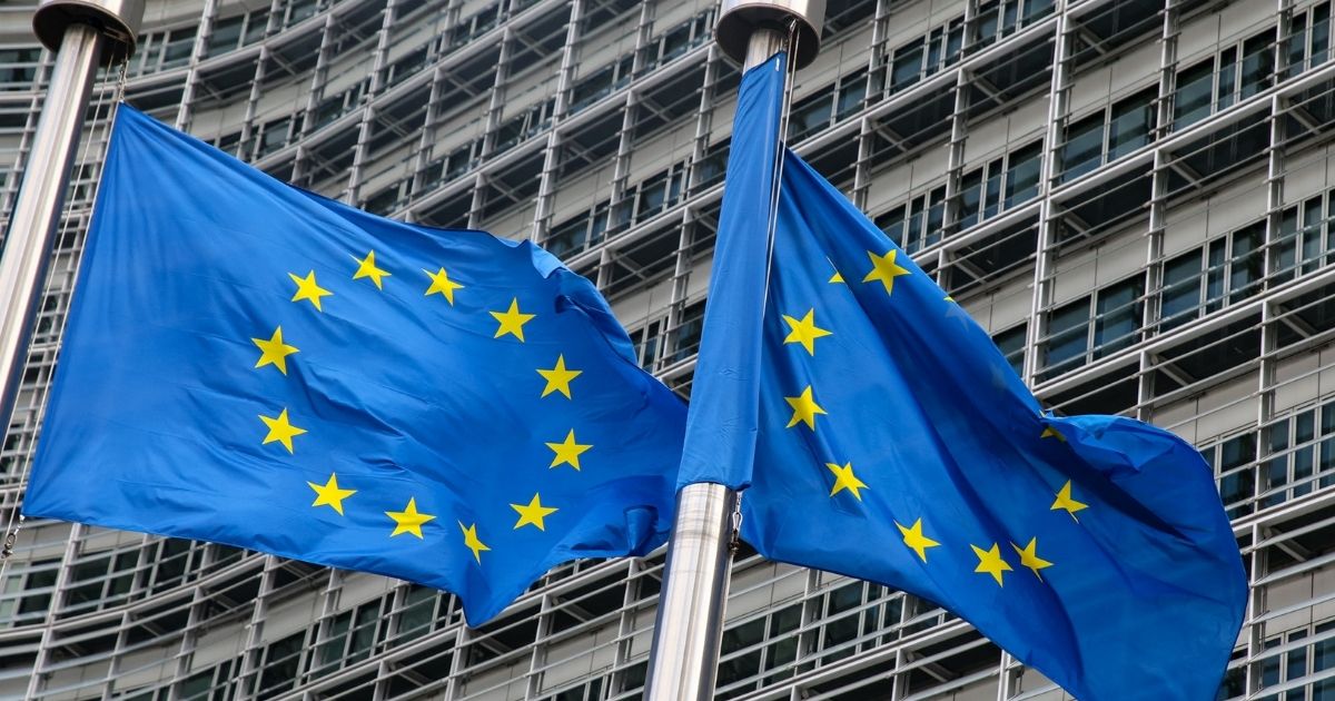 European Union flags fly outside the headquarters of the European Commission in Brussels on March 11, 2021.