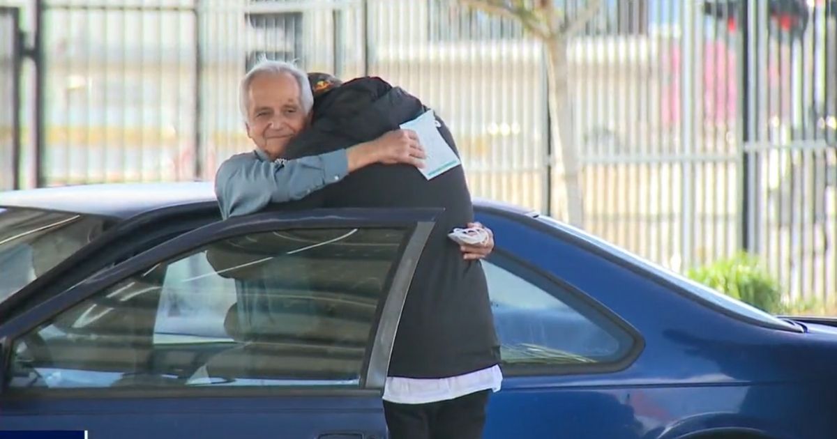 Former teacher Jose Villarruel hugs former student Steven Nava, who raised $27,000 for Villarruel.