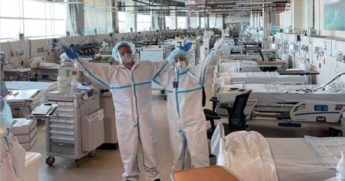 Employees at Cox South Hospital in Springfield, Missouri, pose in an empty ICU unit dedicated to COVID-19 patients.