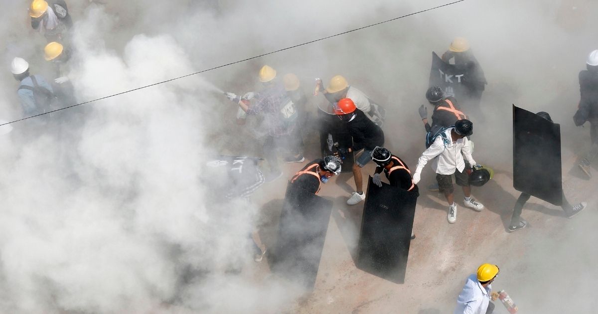 Protesters are engulfed by tear gas during a demonstration against a military coup in Yangon, Myanmar, on March 6, 2021.