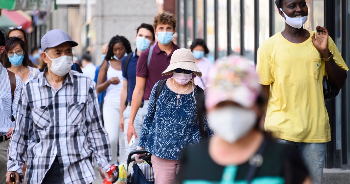 People wear face masks in Chinatown on Aug. 3, 2020, in New York City.