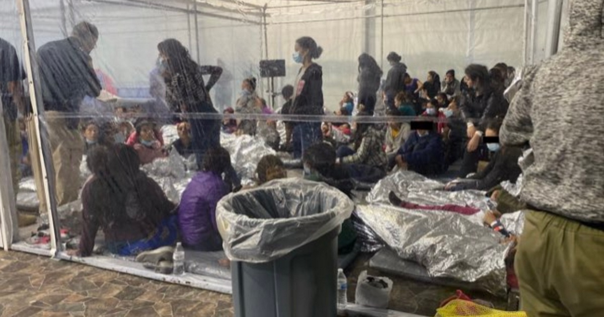 An image of migrants youths crammed into a detention center.