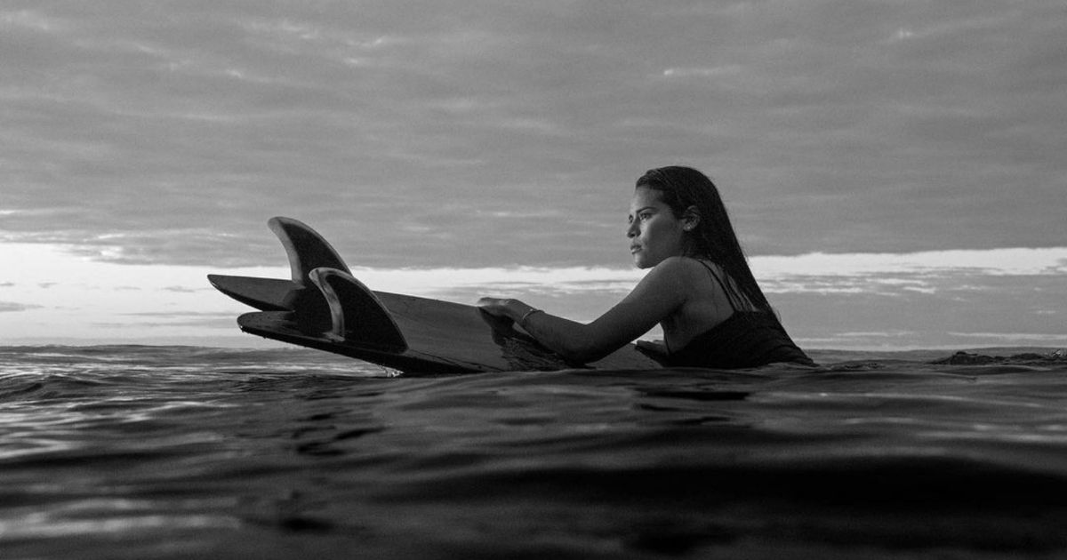 Katherin Diaz on a surfboard in the water