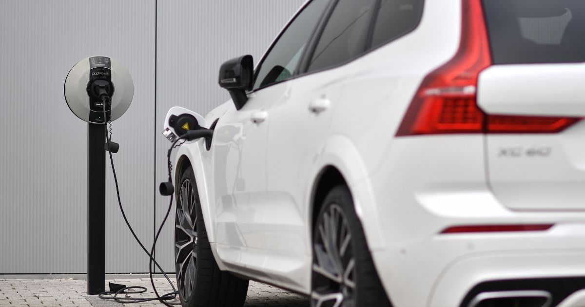 A Volvo XC60 electric car is seen plugged into a charging station outside a Volvo dealership in Reading, west of London, on March 2, 2021.