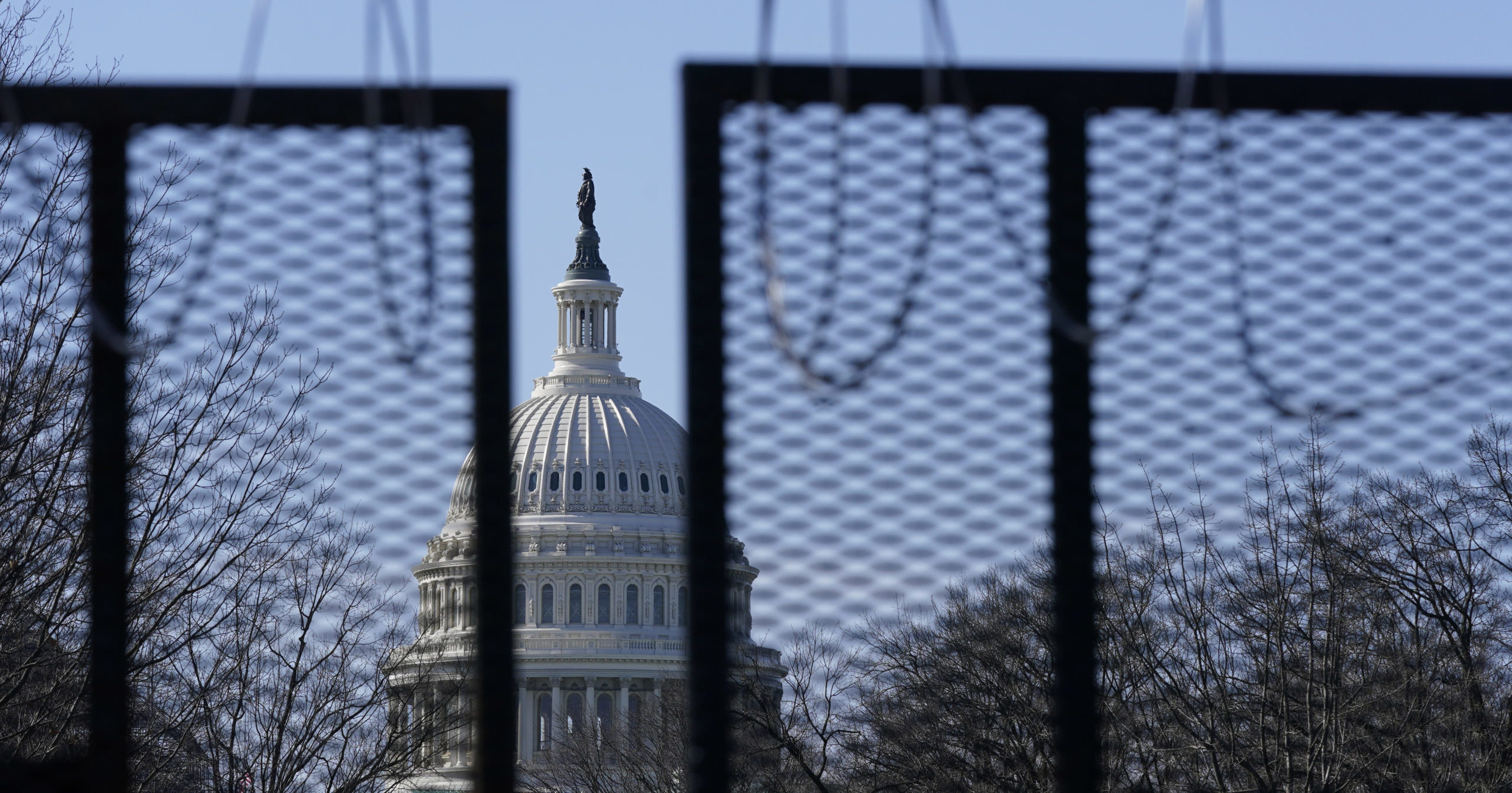 The US Capitol stands behind razor wire hanging from a security fence on Capitol Hill in Washington, D.C., on March 20, 2021.