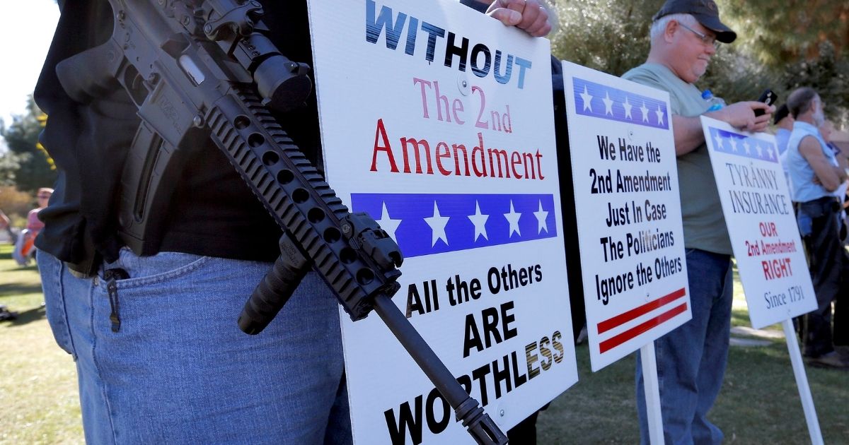 Gun rights supporters stand outside the Arizona Capitol in Phoenix during a pro-Second Amendment rally Jan. 19, 2013.