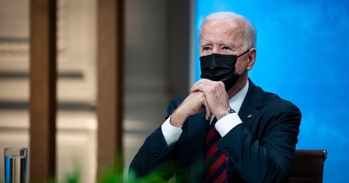 President Joe Biden listens during a virtual Leaders Summit on Climate with 40 world leaders while wearing his mask on Thursday in Washington, D.C.