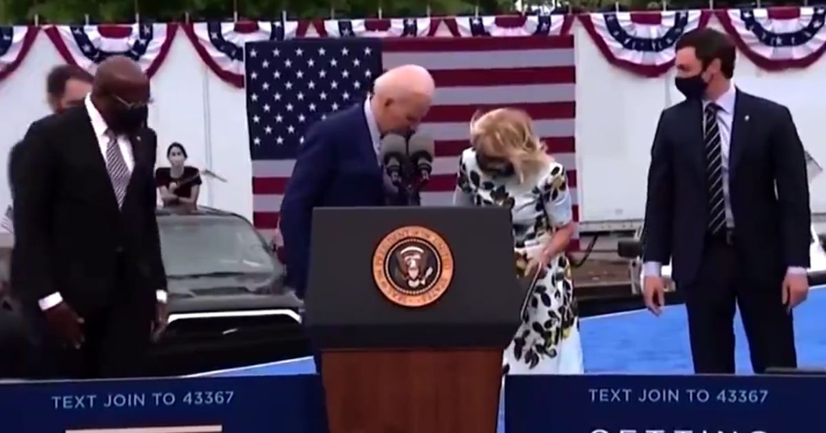 President Joe Biden searches for his mask after delivering a speech in Georgia on Thursday.