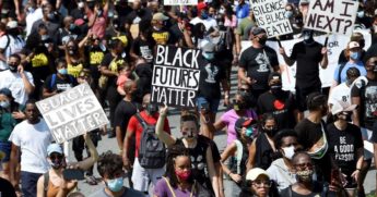 People hold placards at the Lincoln Memorial s they attend the "Commitment March: Get Your Knee Off Our Necks" protest against racism and police brutality, on Aug. 28, 2020, in Washington, D.C.