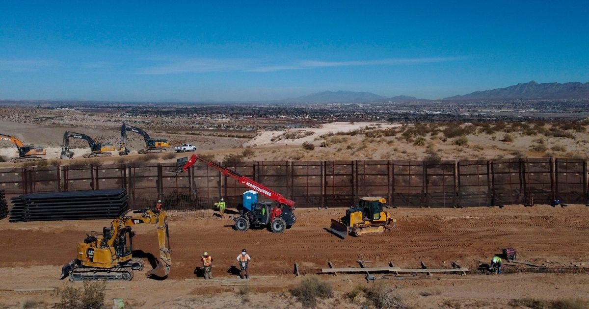 A construction crew works on building a 13-mile stretch of border wall in the desert between Sunland Park, New Mexico, and Ciudad Juarez, Mexico, on Jan. 15 during the last day of Donald Trump's presidency.