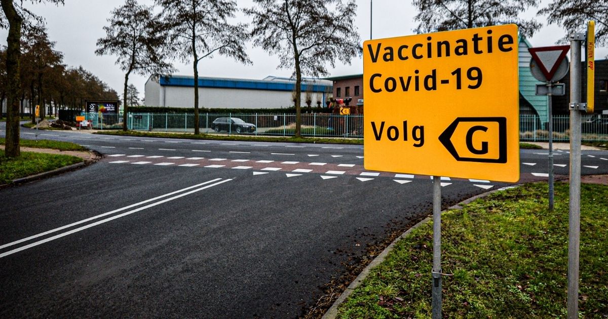 A sign indicating a COVID-19 vaccination site is set up in a former supermarket distribution center on Jan. 5, 2021, in Veghel, Netherlands.
