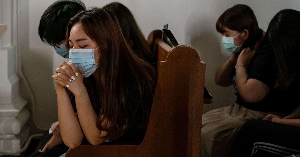 Pro-democracy supporters pray during a memorial service in a church on June 28, 2020, in Hong Kong.