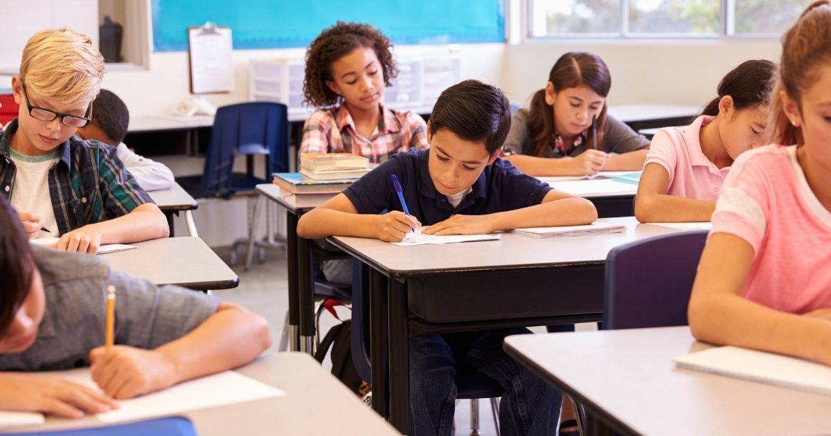 A classroom of elementary school students is pictured in the stock image above.