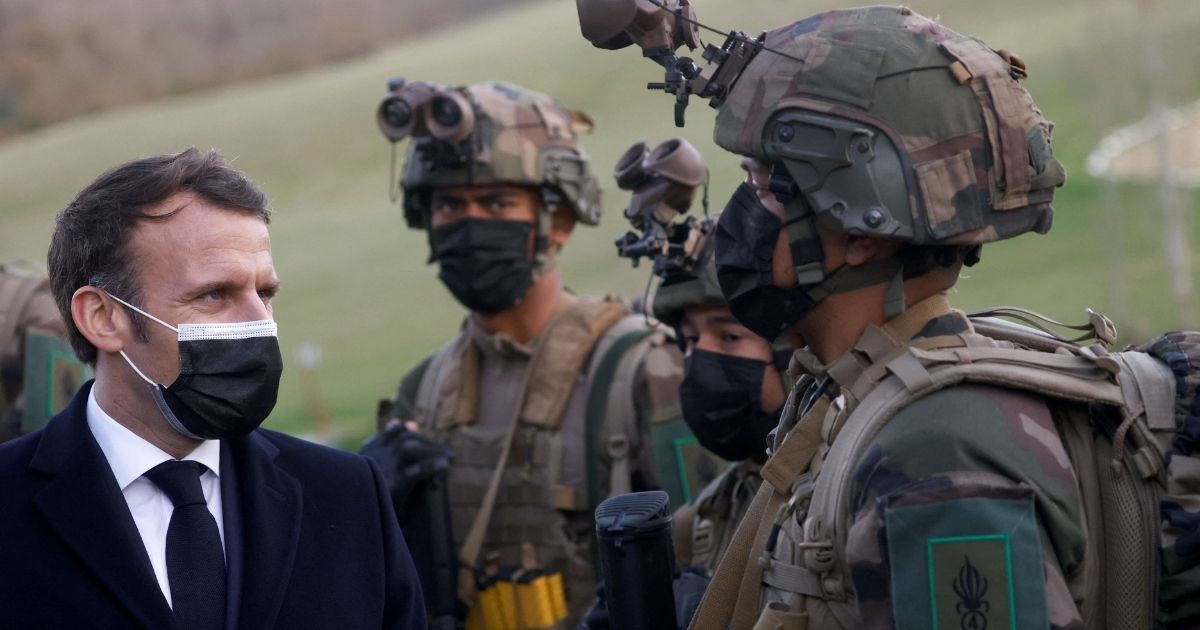 French President Emmanuel Macron, left, speaks with a soldier during a visit to the training centre of the 4th Regiment of the French Foreign Legion, in Saint-Gauderic, southern France, on March 12, 2021.