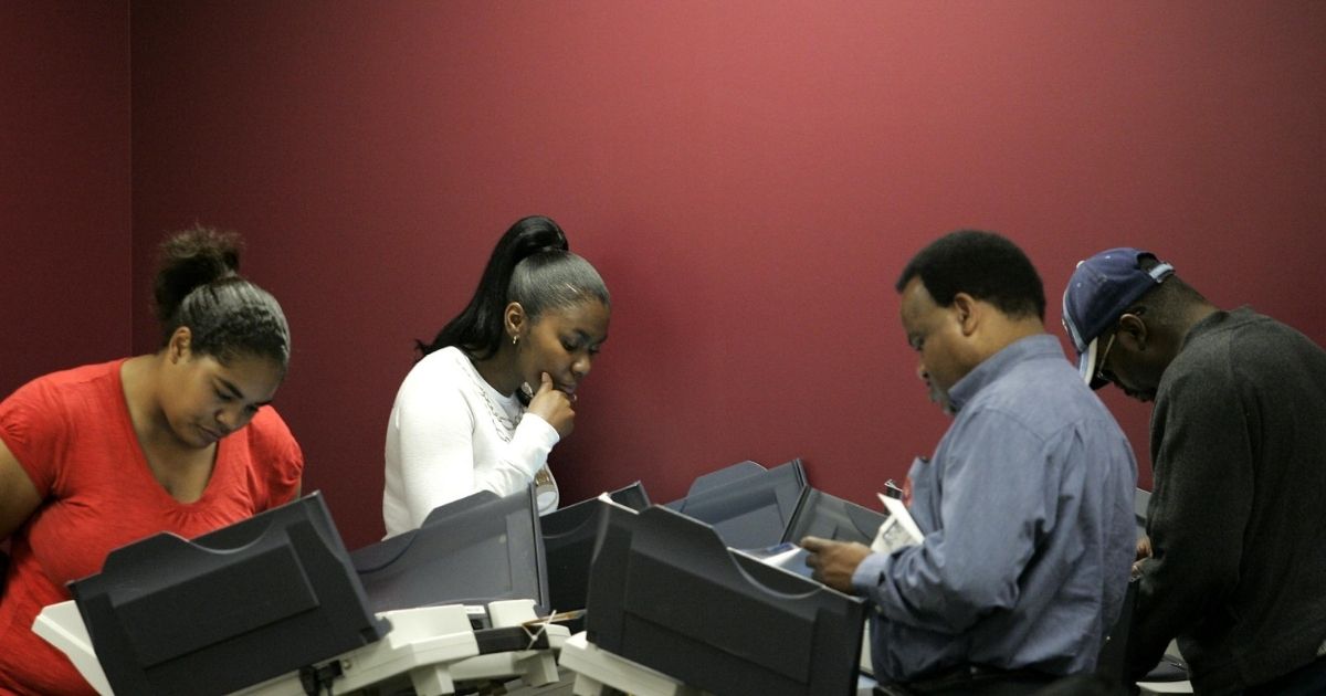 People cast their absentee ballots using electronic voting machines during early voting on Oct. 1, 2008, in Toledo, Ohio.