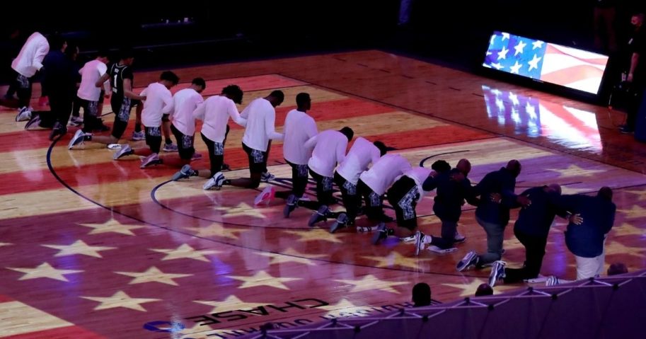 The Georgetown Hoyas kneel during the national anthem before playing the Creighton Bluejays in the Big East championship game at Madison Square Garden in New York City on March 13.