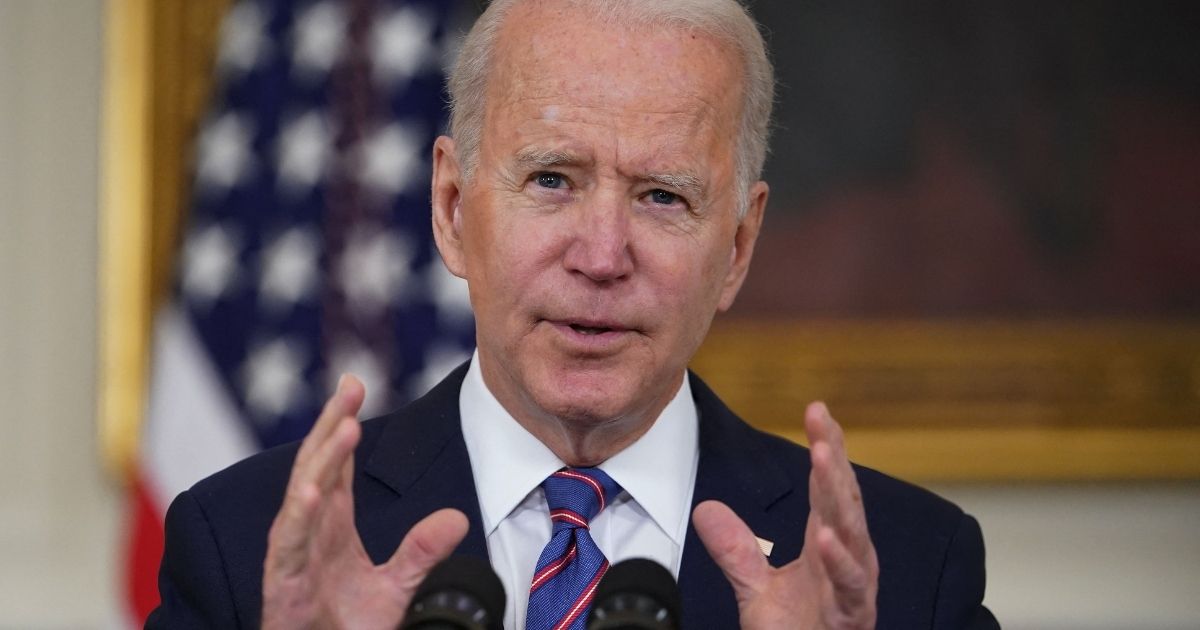 President Joe Biden speaks in the State Dining Room of the White House in Washington on Friday.