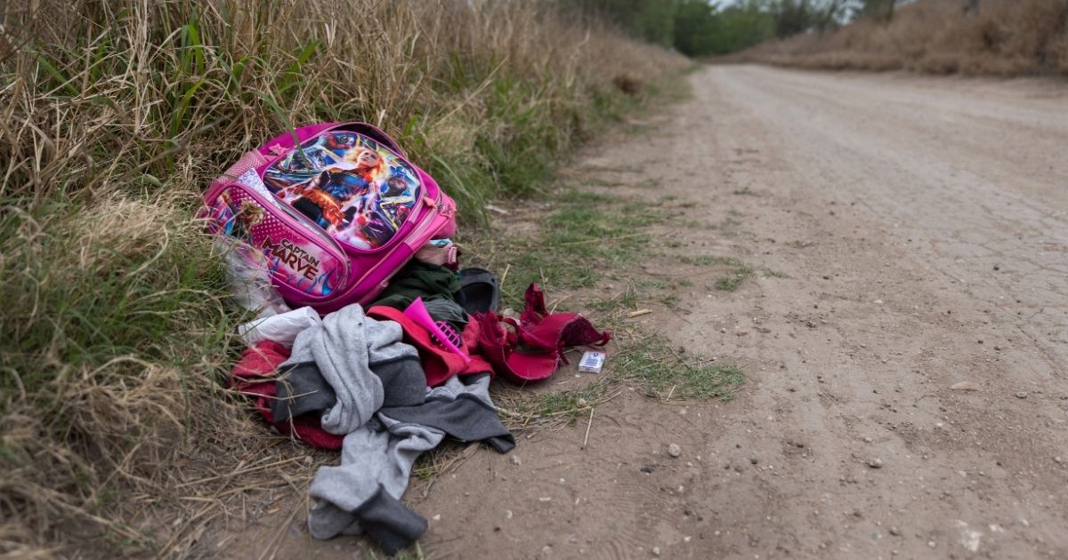 A child's abandoned backpack and clothing lie near an illegal river crossing point at the U.S.-Mexico border on March 24 in McAllen, Texas.