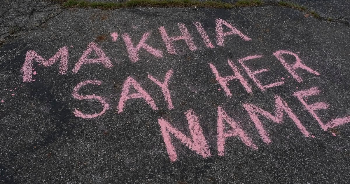 Supporters write messages in chalk at a vigil in Columbus, Ohio, on Wednesday in memory of Ma'Khia Bryant, who was shot and killed by a Columbus Police Department officer while she was attacking someone with a knife.