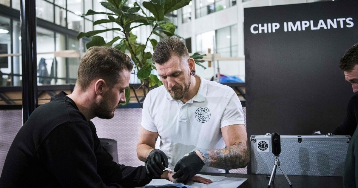 A tattooist and body piercing specialist-turned biohacker, who has chipped most people in the world, implants a chip to a man during a chip implant event in Epicenter, a technological hub in Stockholm on Jan.18, 2018.