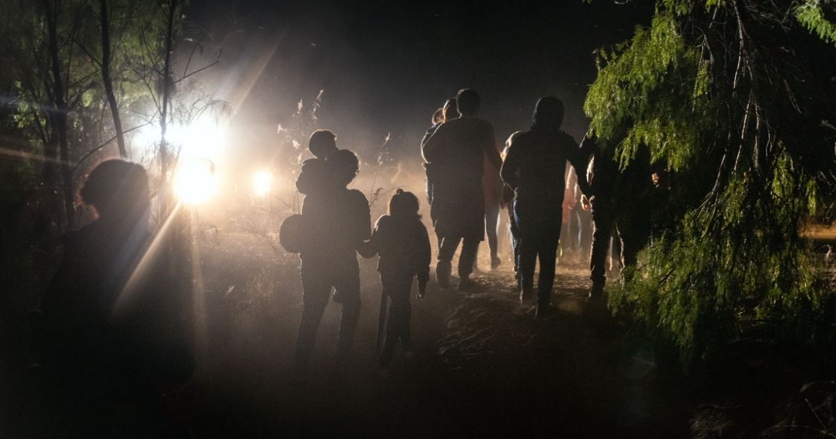 Migrants cross the U.S. border in the dark