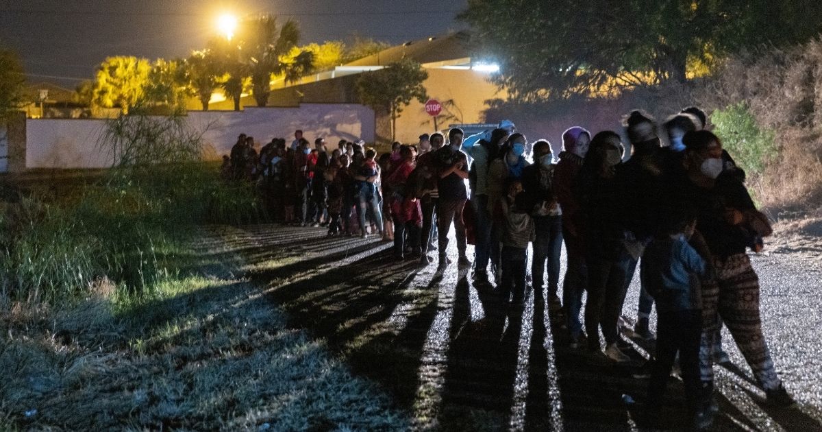 Central American immigrants wait to be processed by U.S. Border Patrol agents after they illegally crossed the Rio Grande from Mexico into Roma, Texas, early on April 10.
